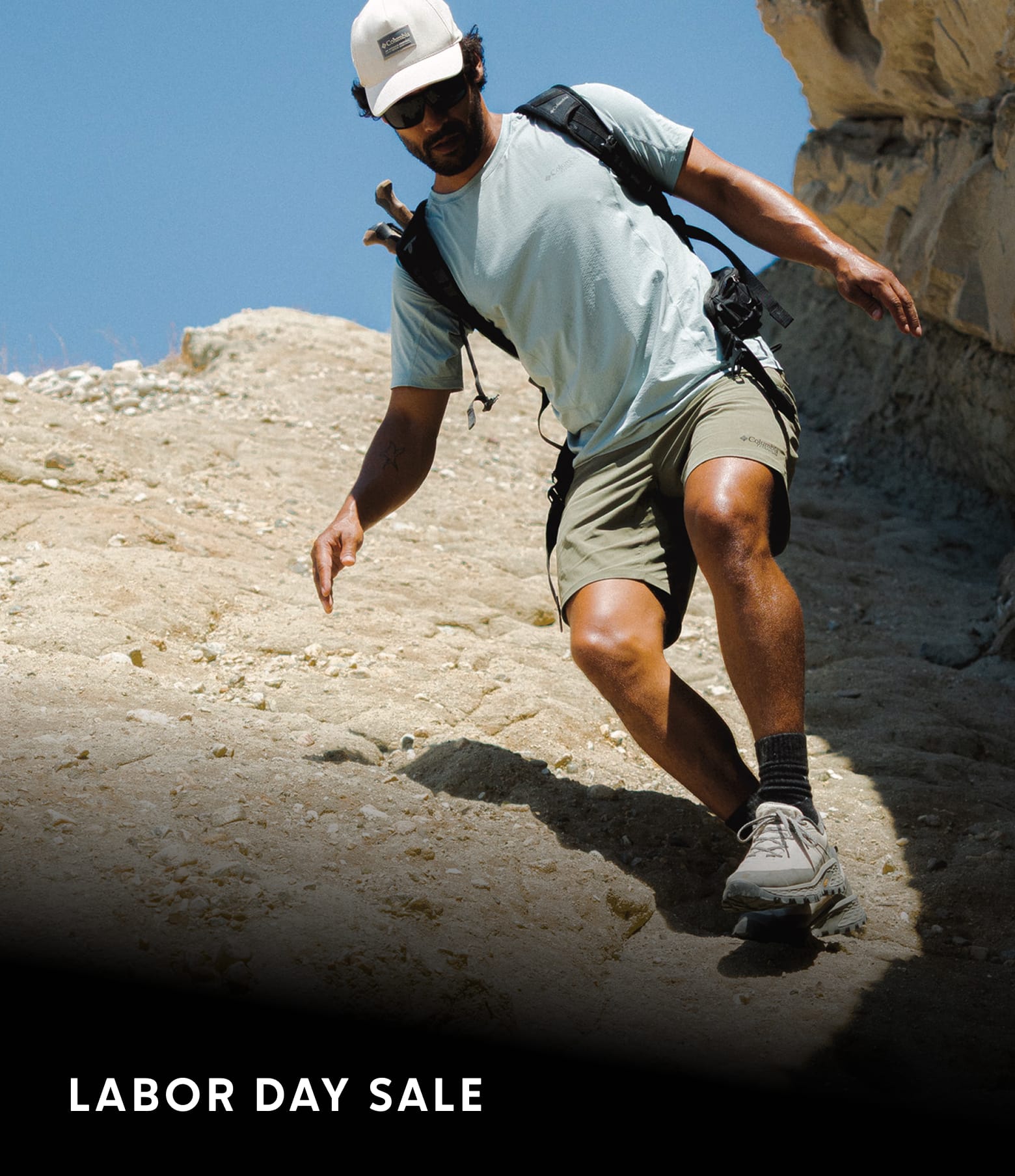 A man hiking on rocky terrain with text 