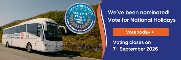 A coach bus parked on a scenic road, surrounded by greenery, promoting a travel award nomination.