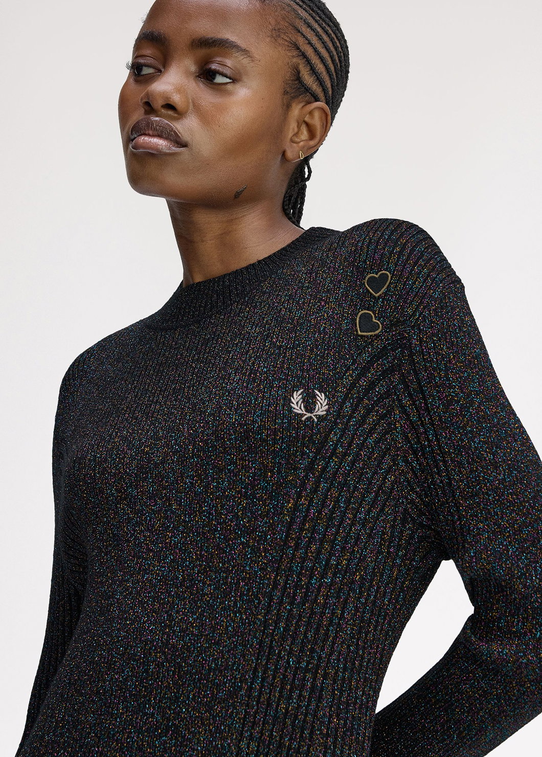 A female model wearing a Fred Perry x Amy Winehouse Foundation Ribbed dress with metallic open-knit design