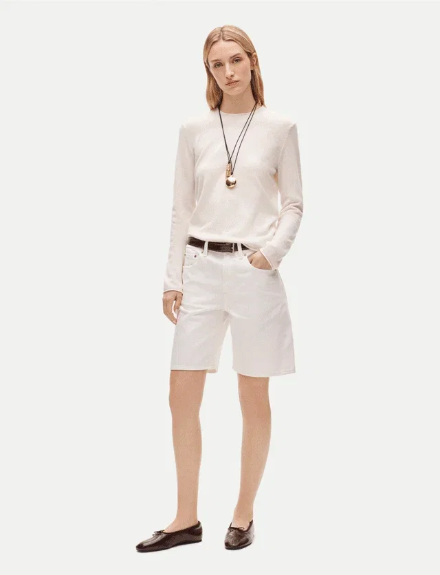 Carousel animation of models wearing classic white sweaters, shop women's sweaters.