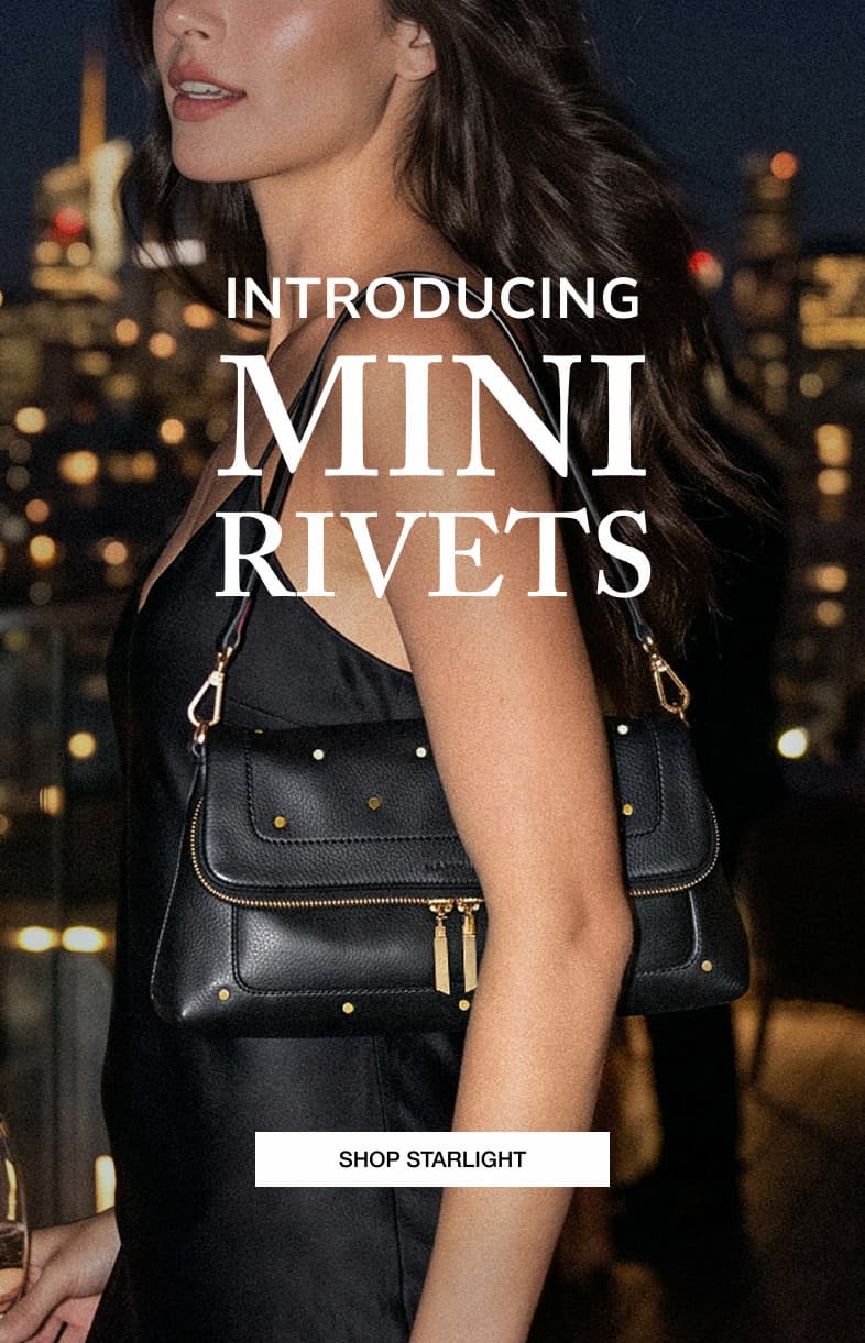 INTRODUCING MINI RIVETS. Model carrying a Starlight Black leather bag with mini brushed gold rivets. SHOP STARLIGHT.