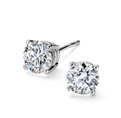Round and emerald-cut diamond stud earrings in white gold settings.