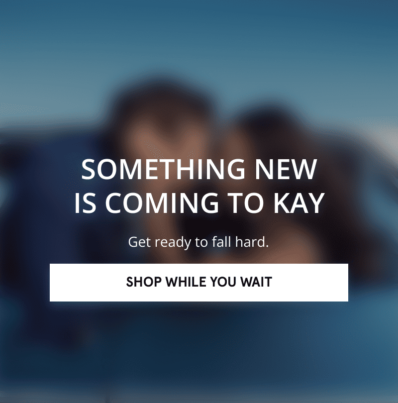 A blurred image of a couple embracing. Something new is coming to KAY. Click shop while you wait.