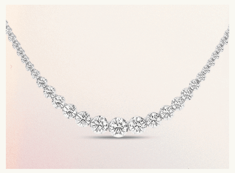 Classic graduated diamond tennis necklace set in white metal.