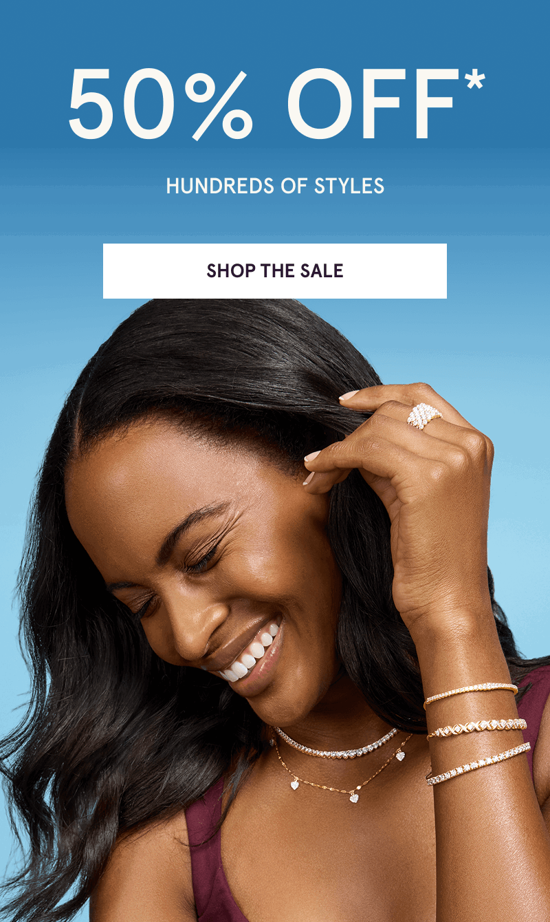 Model layered in diverse diamond bracelets, ring & necklaces. 50% OFF 100s of styles. Click here to shop the sale