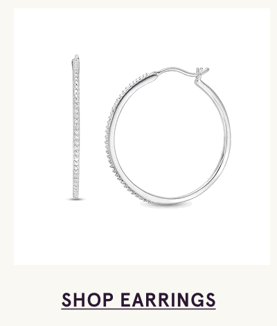 Pair of white-metal hoops lined with round diamonds along the front. Click here to shop earrings