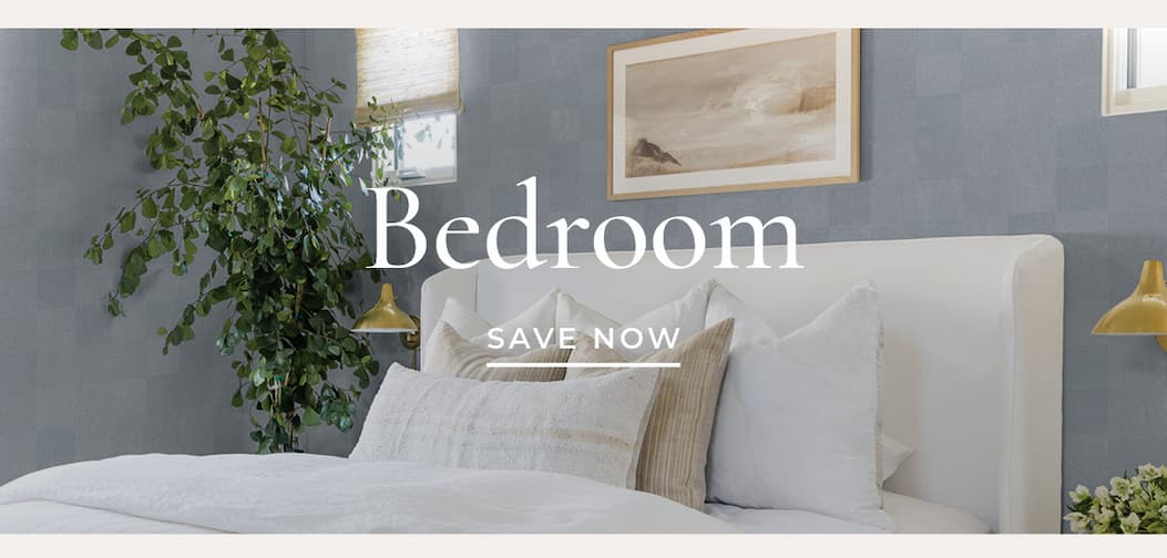 Image of Tempaper's Textured Check wallpaper by Pure Salt in blue installed on a wall behind a bed with multiple decorative pillows. Text overlay "Bedroom Save Now"