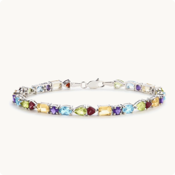 Genuine Multi-Stone Amethyst-Citrine-Blue Topaz-Garnet-Peridot Bracelet: Tennis bracelet featuring alternating oval and pear-shaped multicolored gemstones — blue topaz, citrine, amethyst, peridot, and garnet — set in silver.