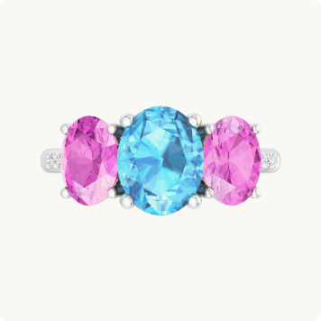 Martha Stewart 5ctw. Oval Blue Topaz, Pink Sapphire & Lab Grown Diamond Three Stone Ring In Sterling Silver: Three-stone ring featuring an oval blue topaz center stone flanked by two oval pink sapphires, with small diamond accents on a white gold band.