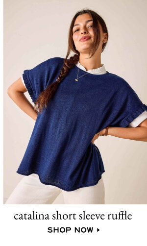 Catalina Short Sleeve Ruffle - Shop Now - Image of a woman wearing a navy short sleeve sweater with ruffle details