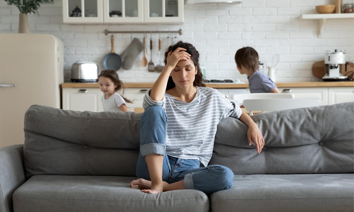 Frustrated woman with kids running around