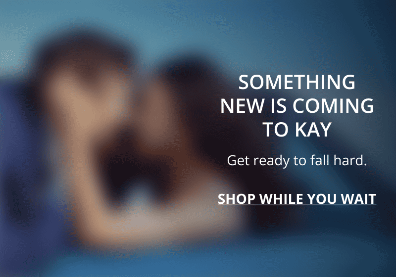 A blurred image of a couple embracing. Something new is coming to KAY. Click shop while you wait.