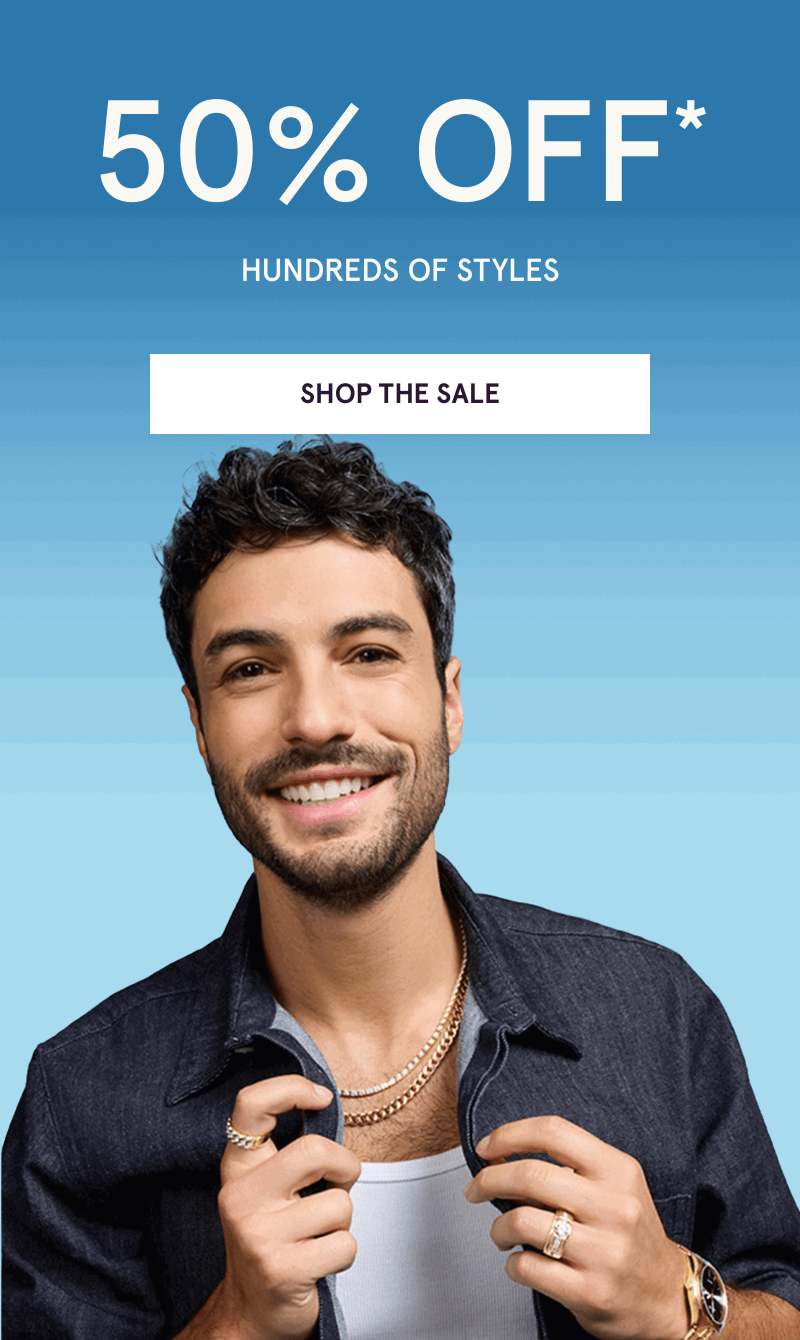 Male model layered in gold necklaces, rings & watch. 50% OFF 100s of styles. Click here to shop the sale