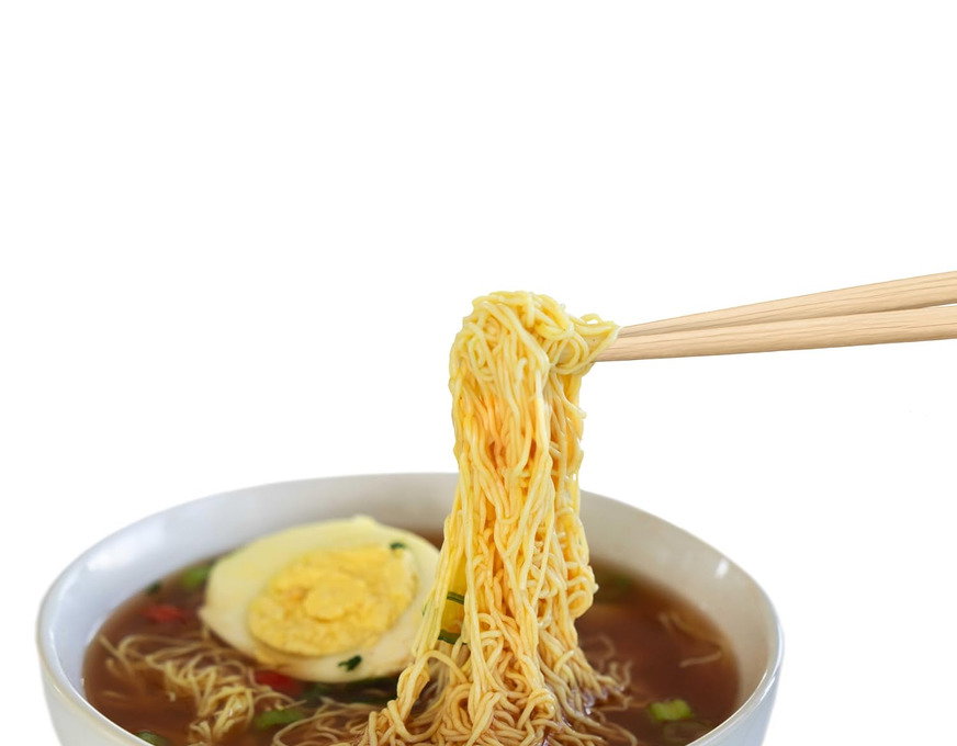 A bowl of Miracle Noodle spicy beef ramen with a soft egg and scallions