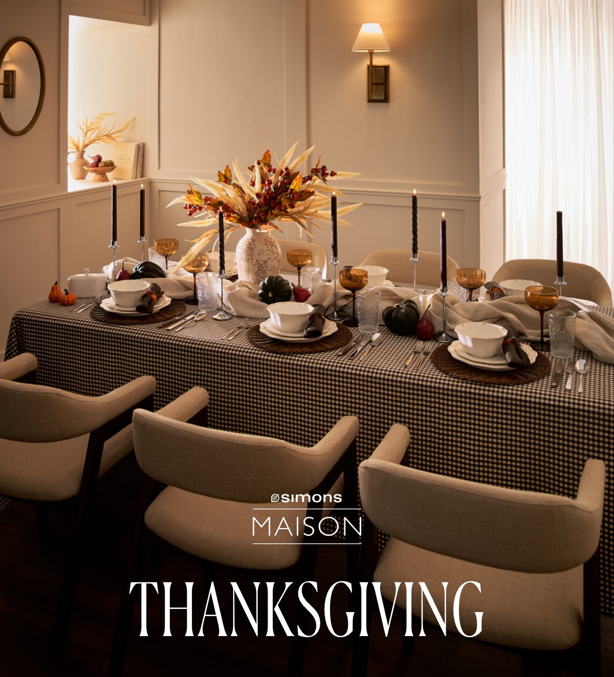 A table set for a grand celebratory meal with a tablecloth, tableware, and fall decorations. Simons Maison. Thanksgiving