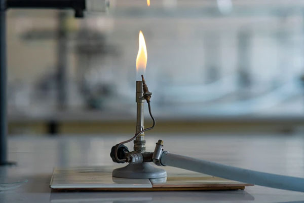 A lit bunsen burner in a laboratory.