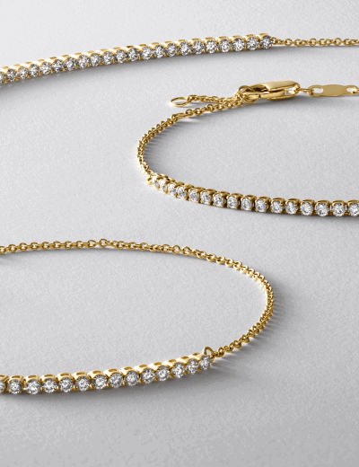 Diamond tennis necklace and bracelet in yellow gold with round brilliant diamonds.
