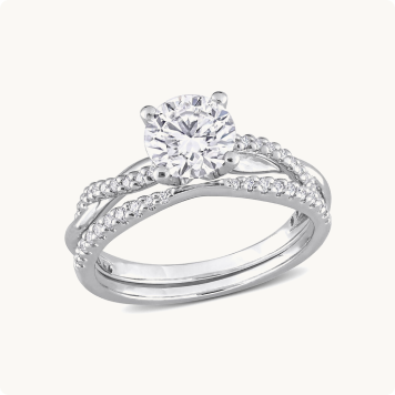 Lab Grown Round-Cut Diamond 1ctw. Twist Bridal Set in 10k White Gold: Round-cut diamond engagement ring paired with a matching diamond-lined wedding band, both in white gold.