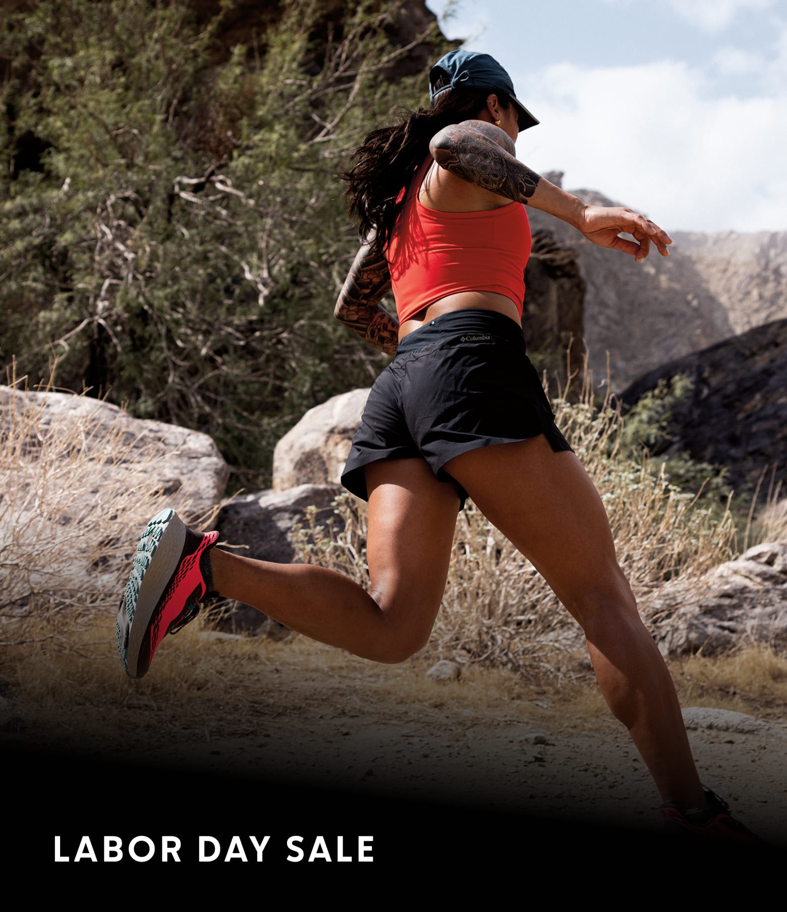 A woman running on a dirt path with hills in the background and text LABOR DAY SALE
