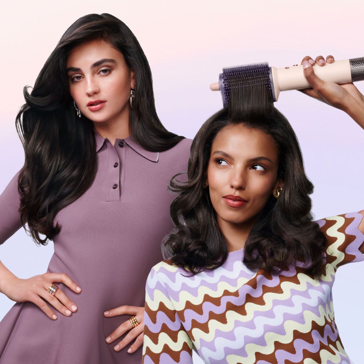 Pair of models styling their hair with the Dyson Airsmooth styling brush.