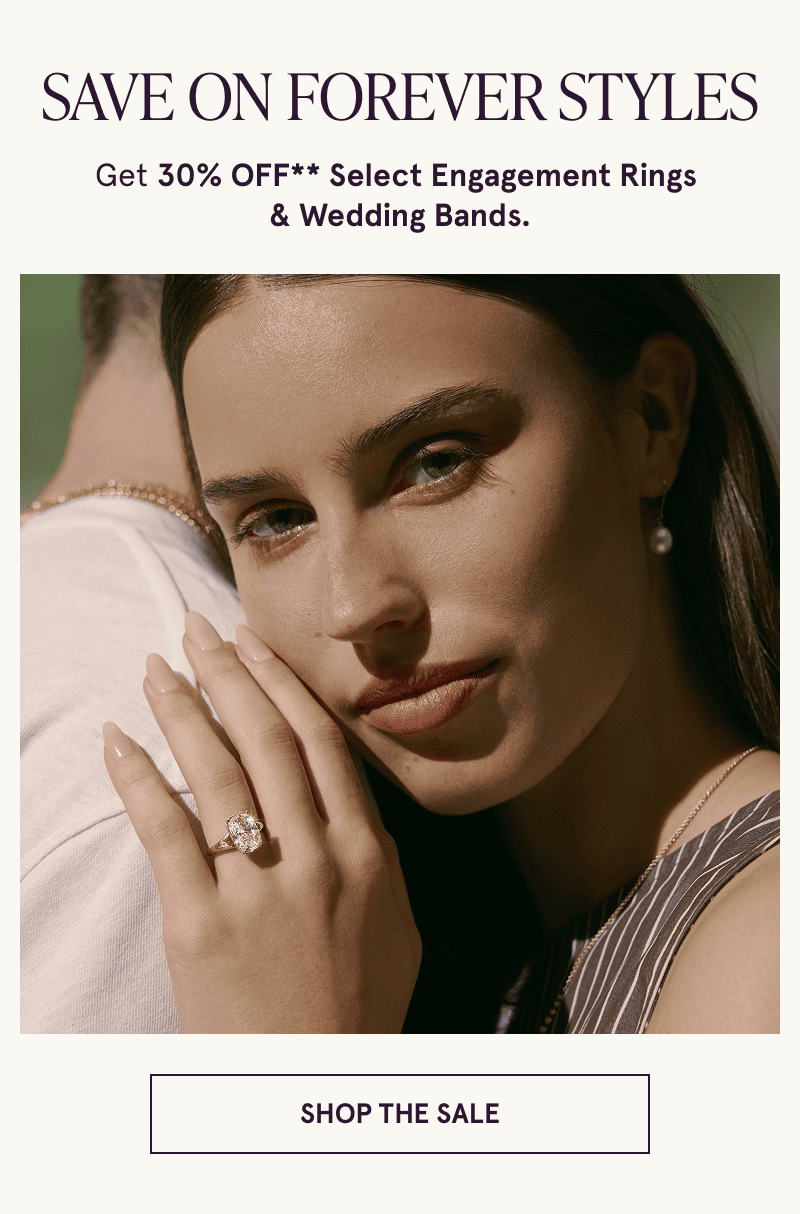 Model wearing an engagement ring hugs another model. 30% off select engagement and wedding rings. Click to shop the sale