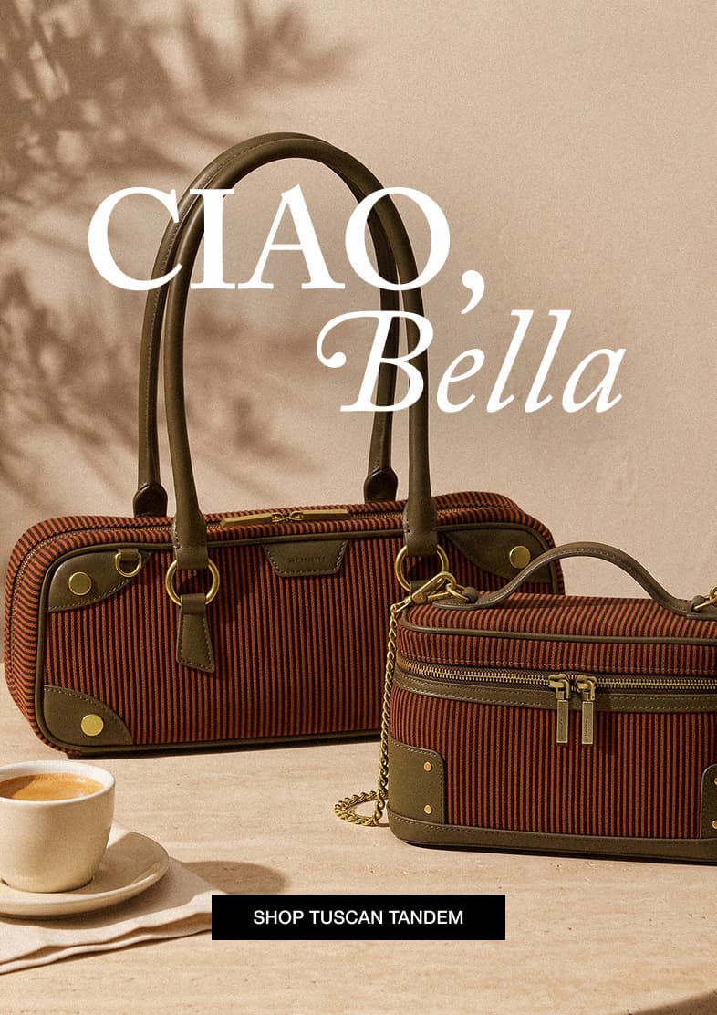 CIAO, Bella. Two Tuscan Tandem bags featuring terracotta and espresso stripes with rich green leather trim and gold hardware, styled beside a cup of coffee. SHOP TUSCAN TANDEM.