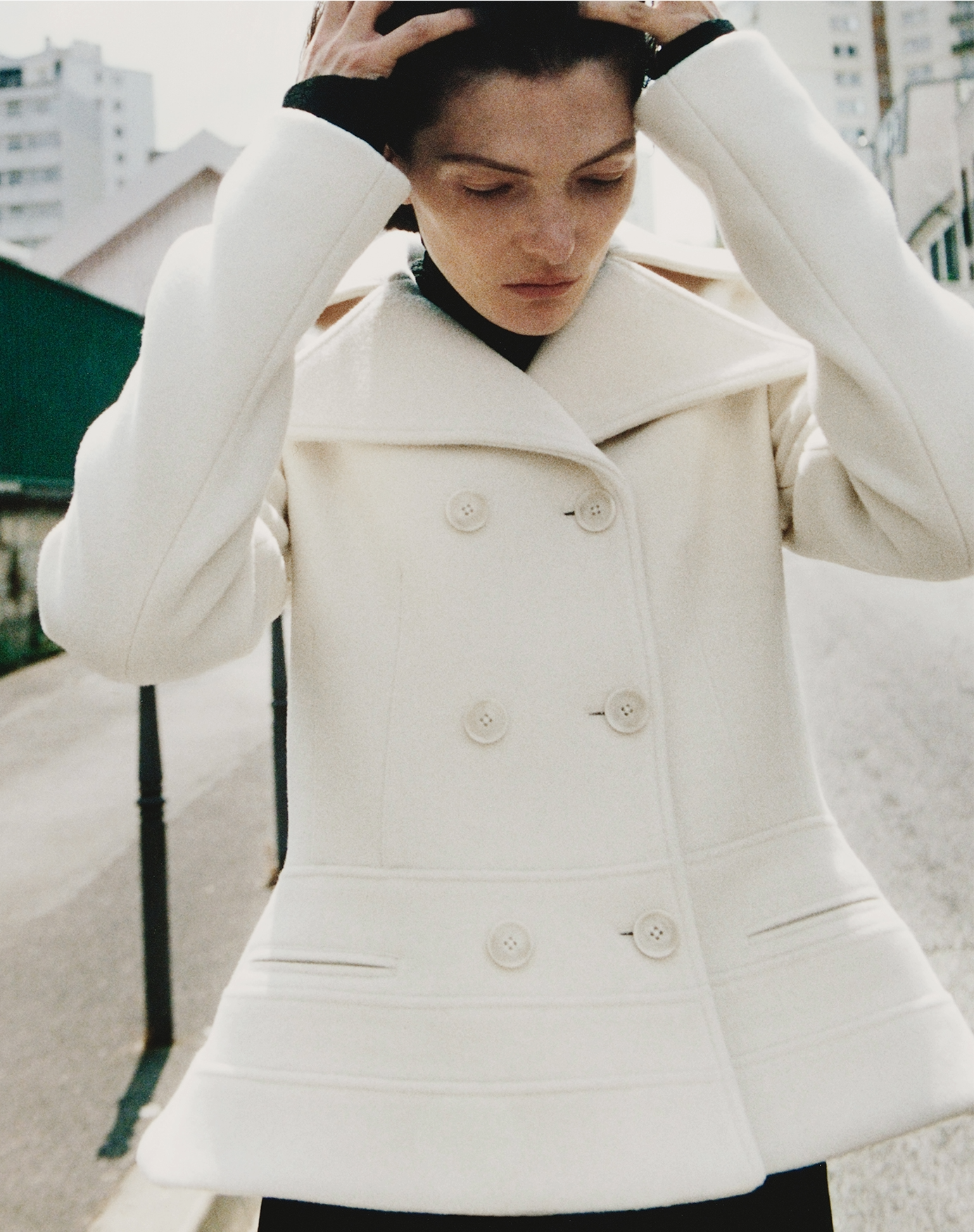 Campaign image of model wearing the Romane Jacket in Compact Melton Wool in Ivory