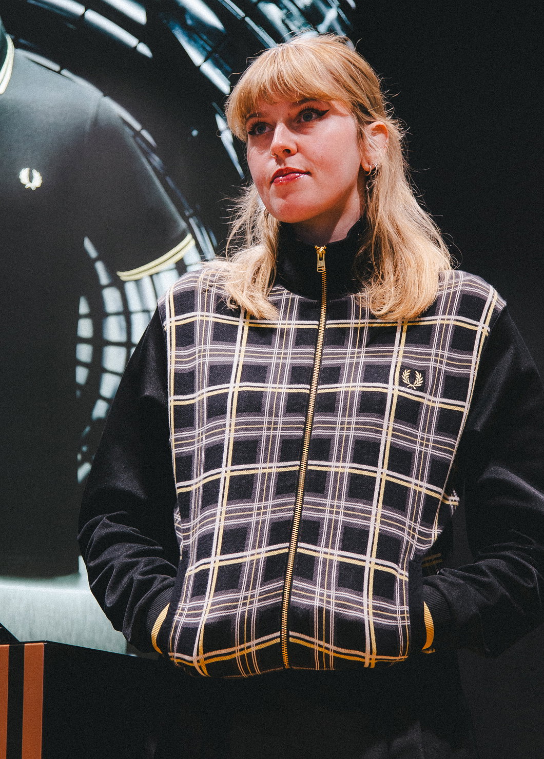 Female wearing a Fred Perry Tartan Panel Track Jacket in Black Champagne
