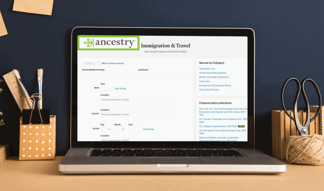 A laptop on a desk displays an Ancestry.com webpage for searching immigration and travel records.
