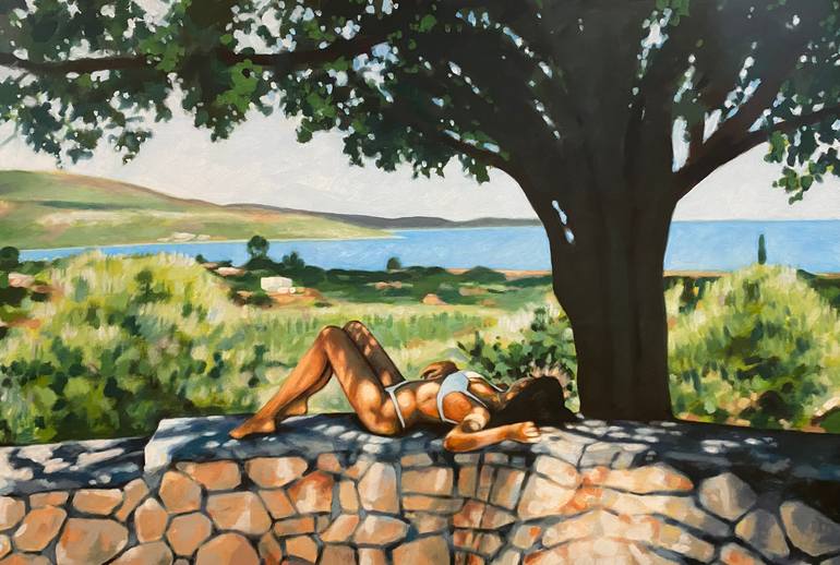 Woman sitting under a tree in the summer