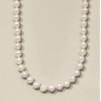 A pearl beaded necklace on textured background.