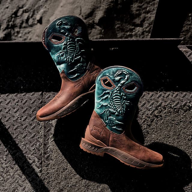 A pair of stinger boots in blue and brown.