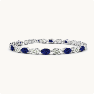Oval-Cut Created Sapphire & Lab Grown Diamond Bracelet in 14k White Gold: Tennis bracelet alternating oval blue sapphires and oval diamonds set in white gold.