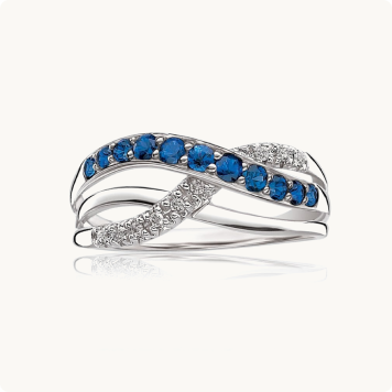 Sapphire & Diamond Crossover Ring in 10k White Gold: Crisscrossing white gold ring with one band of round blue sapphires and another lined with pavé diamonds.