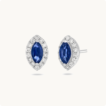 Marquise Created Blue Sapphire Halo Lab Grown Diamond Earrings in Sterling Silver: Pair of marquise-cut blue sapphire stud earrings surrounded by a halo of round diamonds, set in white gold.