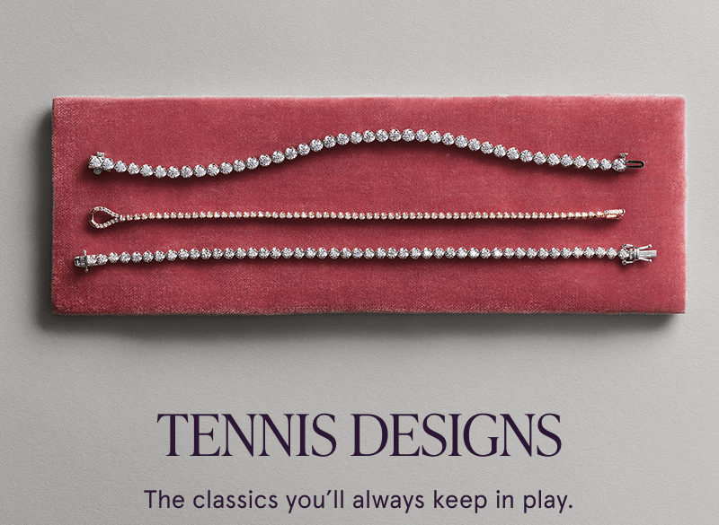 Three diamond tennis bracelets in varying stone sizes arranged horizontally across red velvet display pad.  Tennis designs.