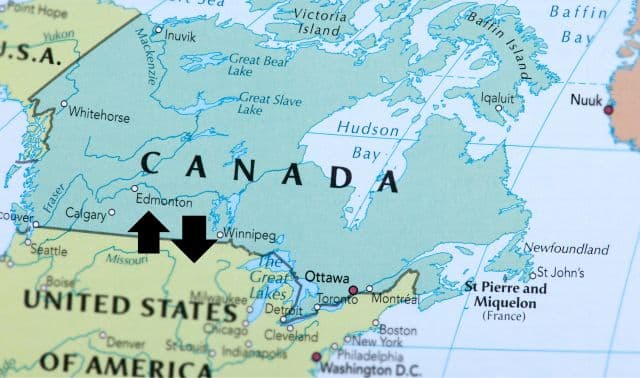 Map of eastern and central Canada and northern United States, with two black arrows pointing to a location in western Canada, near the Alberta-Saskatchewan border.