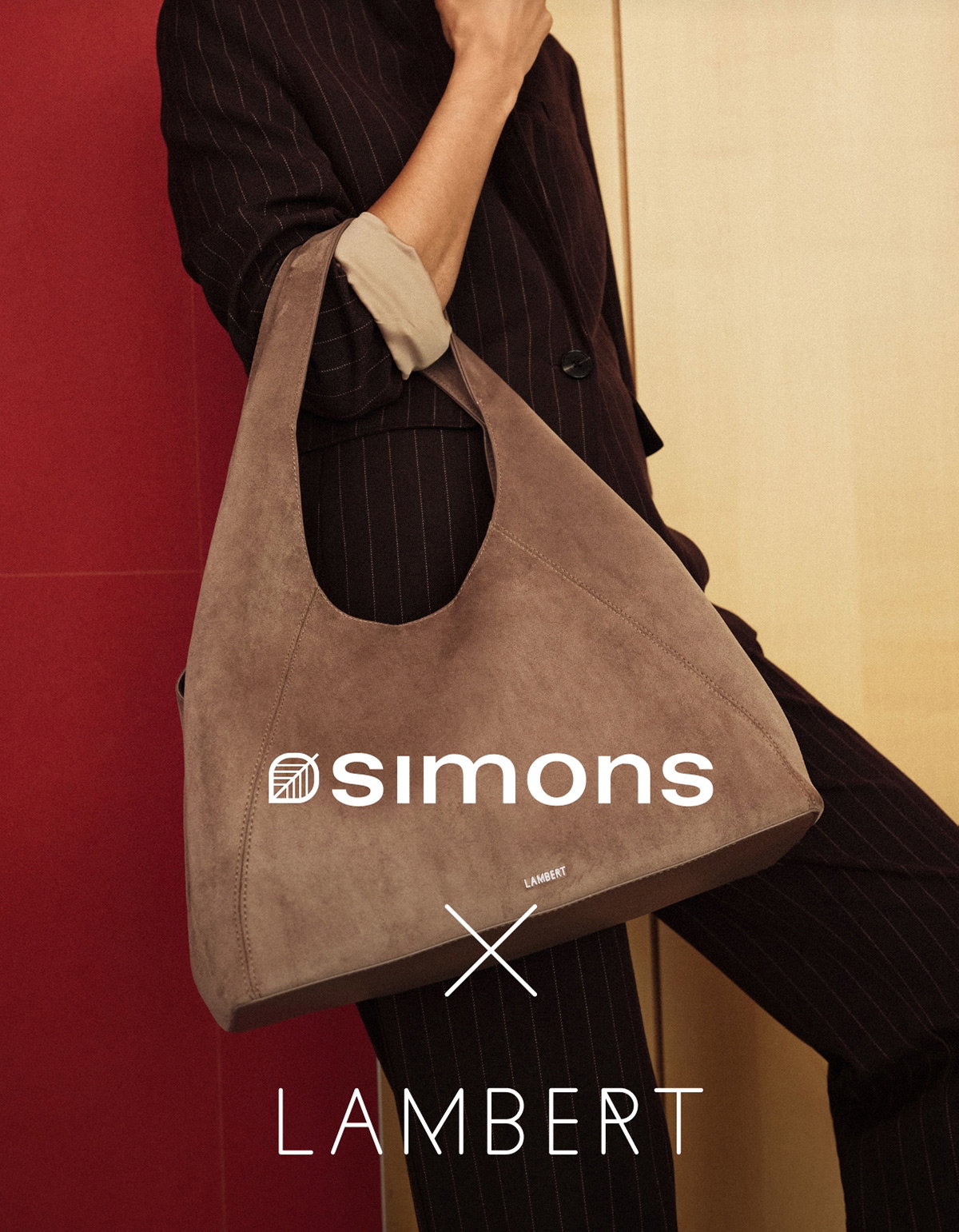 Simons x Lambert. The photo shows a woman carrying the Belle hobo bag in taupe, part of the exclusive collaboration. 