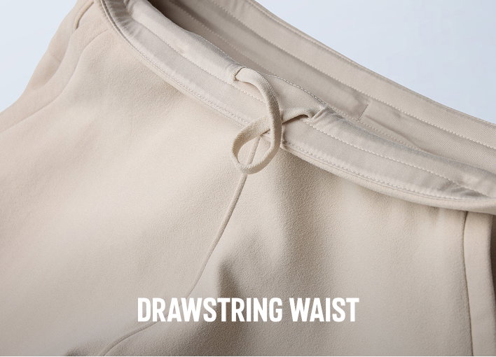 Close-up of a drawstring waist on a white pair of sweats with text: DRAWSTRING WAIST