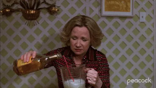 A woman pouring alcohol into a pitcher.