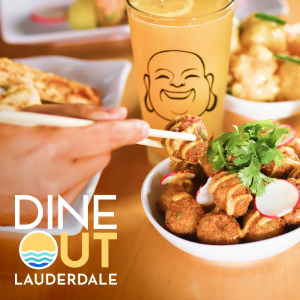 Close-up of a restaurant table showcases a variety of dishes, including a bowl of fried bites topped with cilantro and radish slices. A hand uses chopsticks to pick up food, emphasizing an interactive dining experience. In the background, a tall drink glass features a smiling face illustration. The text "DINE OUT LAUDERDALE" appears prominently with a wave icon, suggesting a coastal dining event.