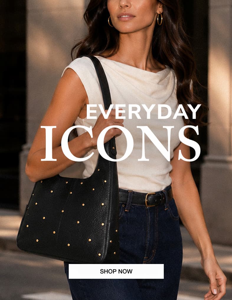 EVERYDAY ICONS. Model carrying a black leather tote detailed with mini gold rivets. SHOP NOW.