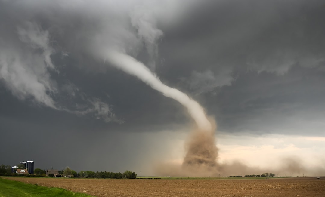 Tornado funnel touching down over a road