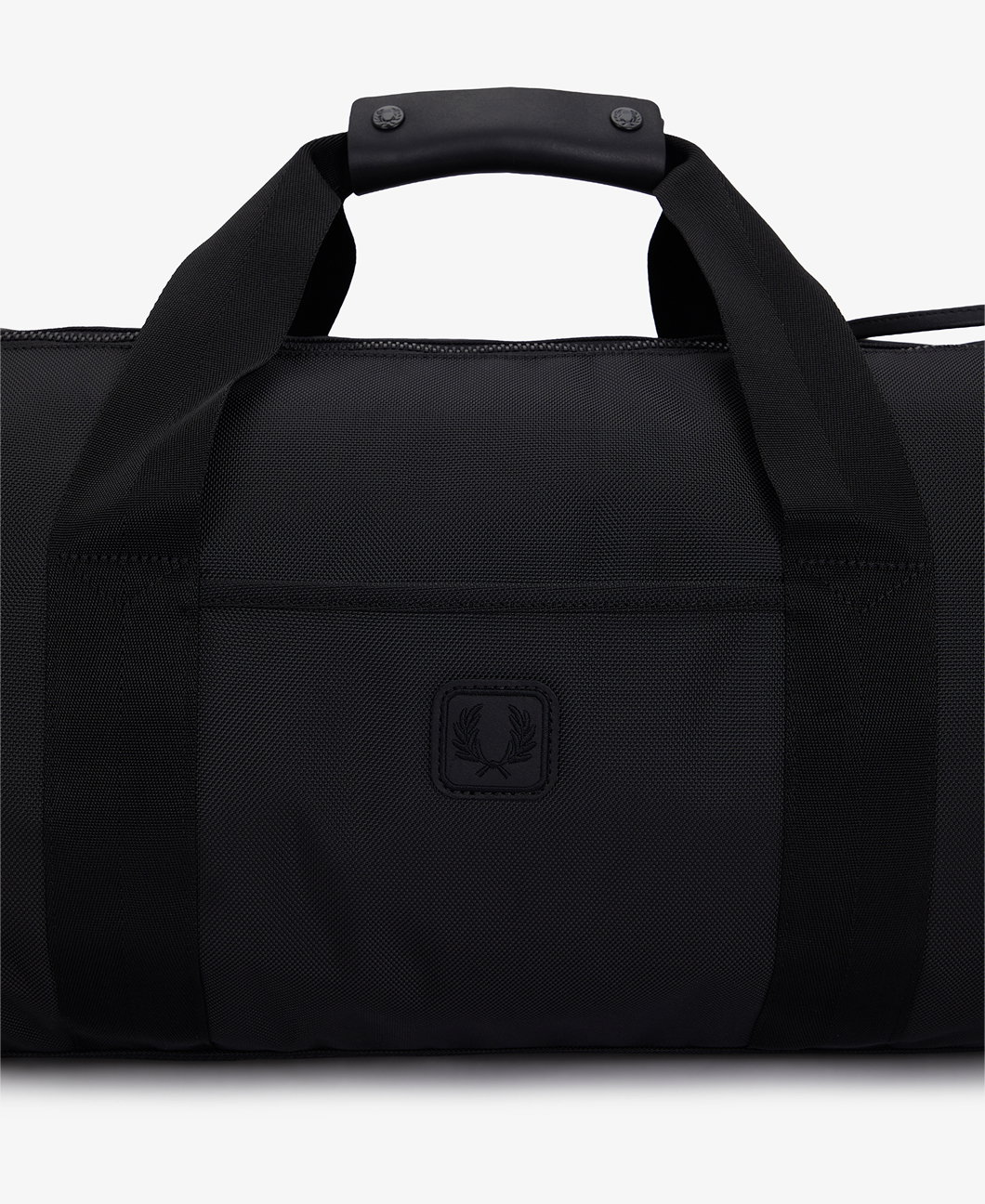 Close up of a Fred Perry Leather Patch Barrel Bag
