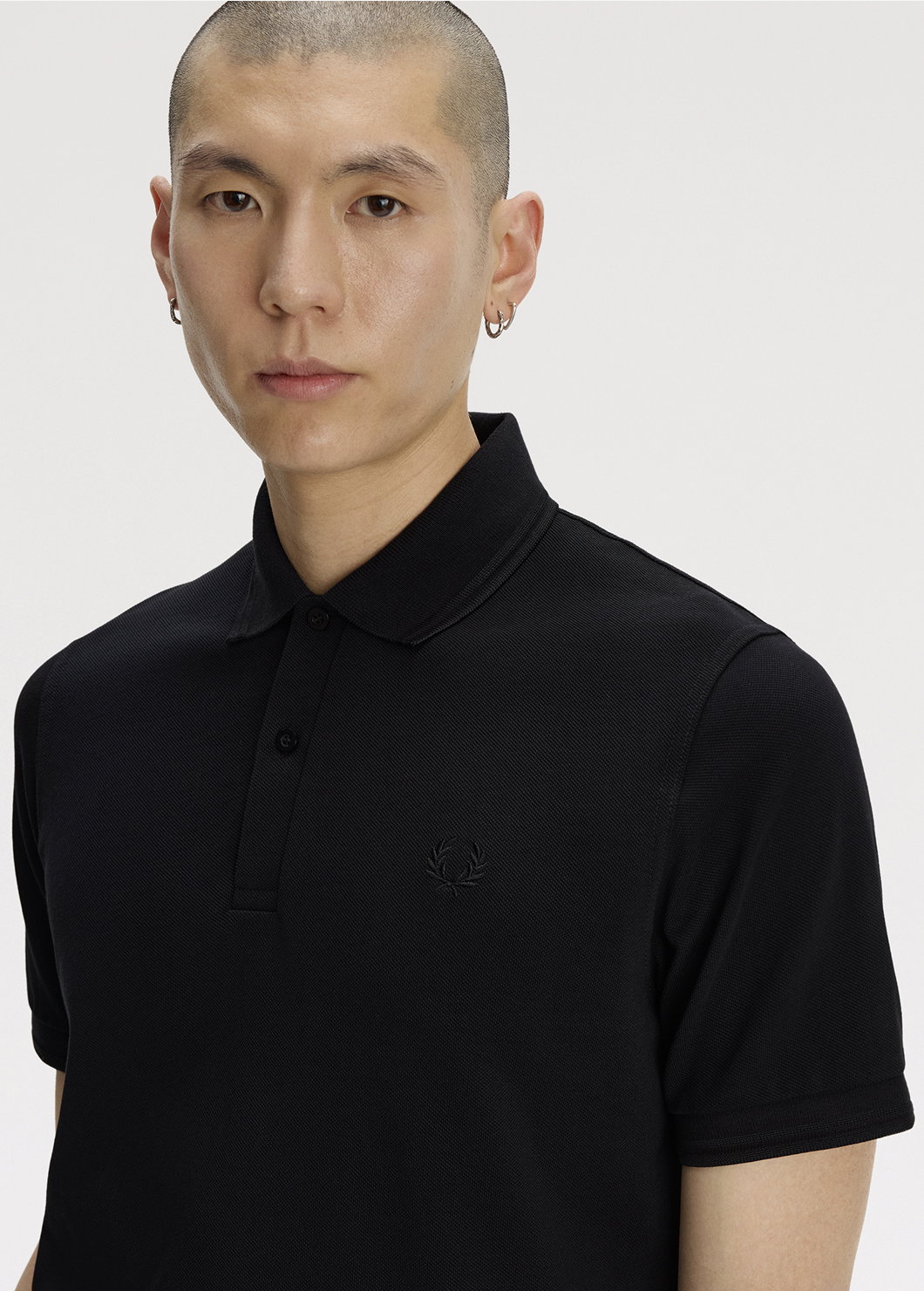 Male model wearing an M12 Fred Perry Shirt in Black