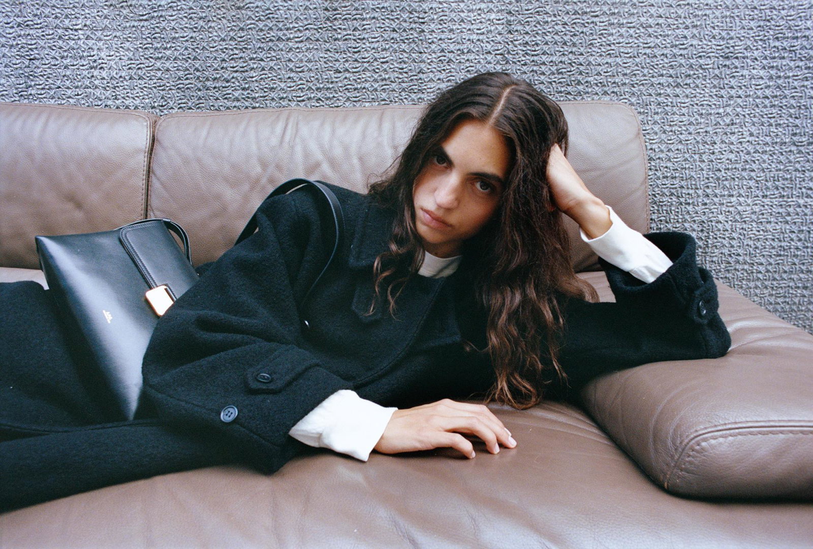 A.P.C. woman laying on couch in fall outift