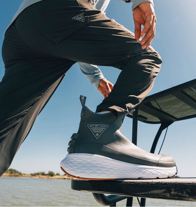 Close up of angler stepping on boat with Dry Tortugas. 