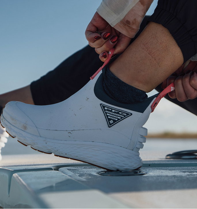 Close up of angler sitting on boat pulling Dry Tortugas boot. 