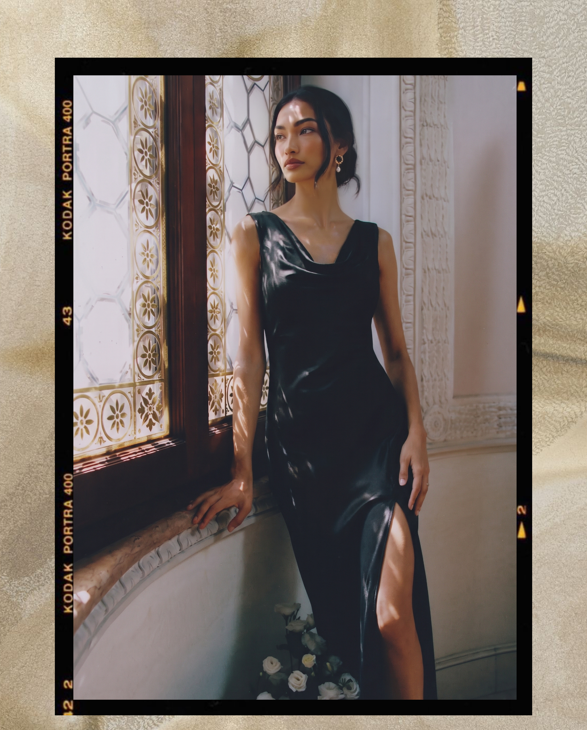 Model in a black satin slip dress