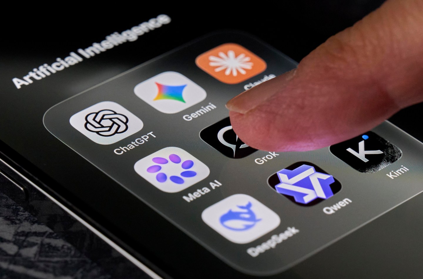 A finger hovers over an app on a smartphone screen.